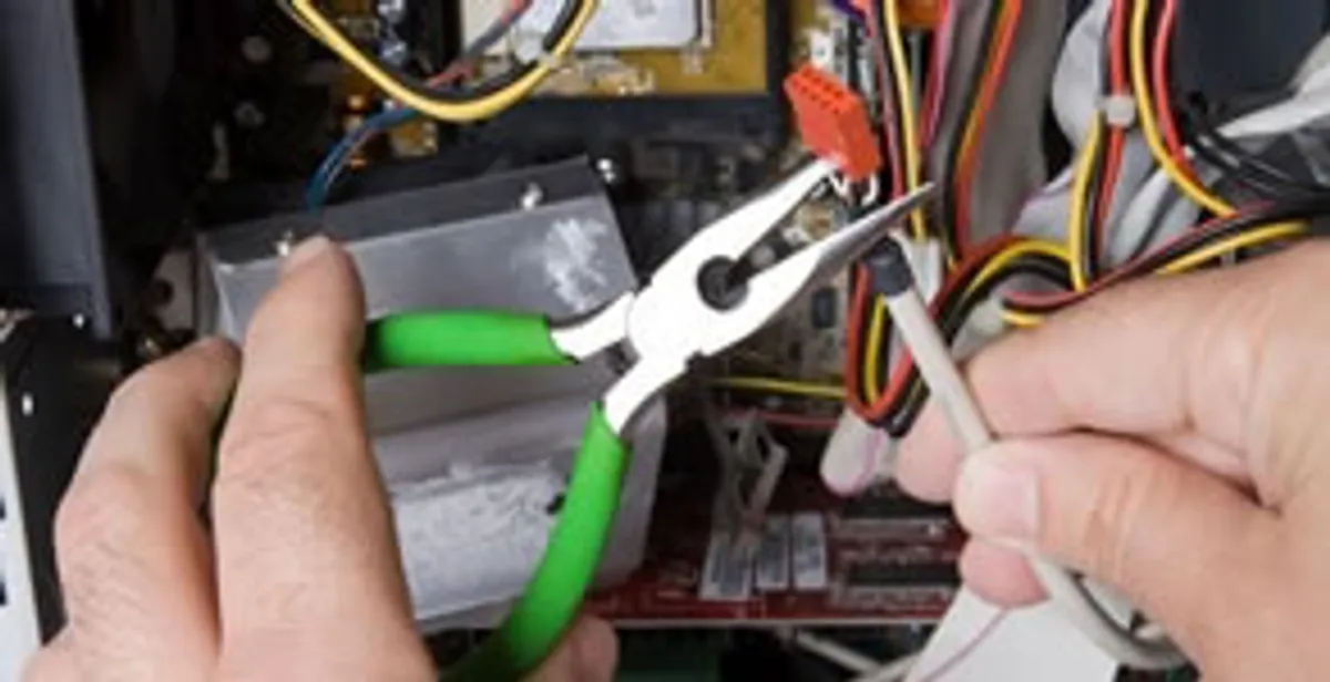 Licensed electrical contractor performing electrical repair with tools in Edwards, IL