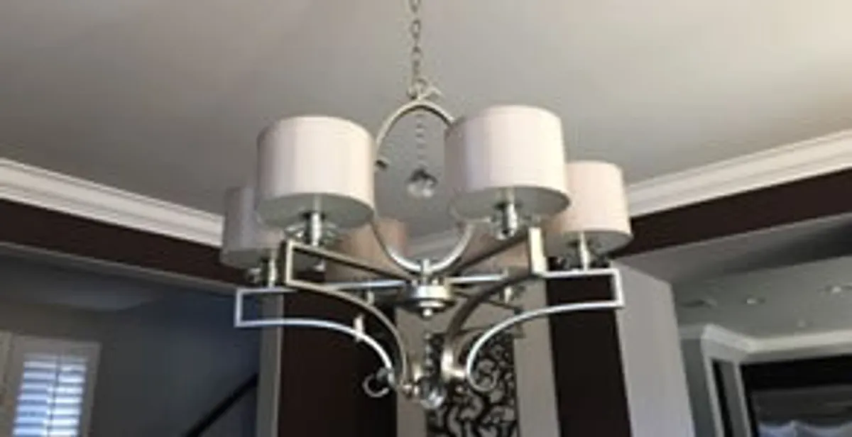 Modern chandelier installation with multiple light fixtures in Peoria, IL